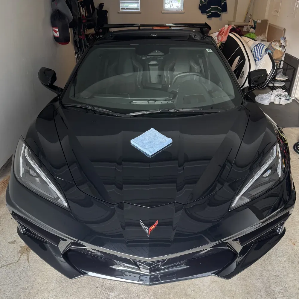 Black Corvette C8 in a client garage after ceramic coating