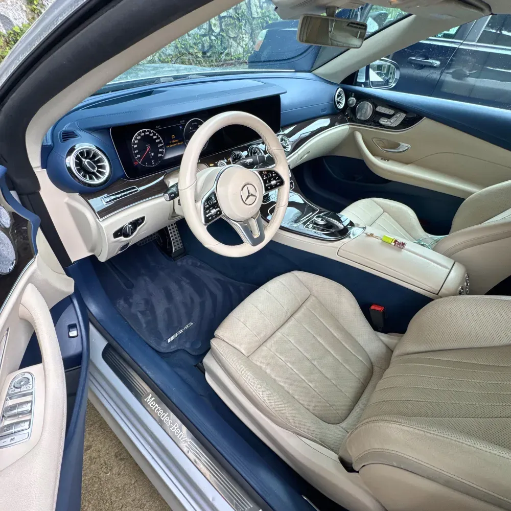 Cream leather and blue trim interior of a Mercedes AMG after a full interior detail