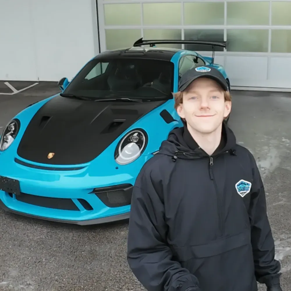 Lucas, owner of North Van Detailing, in front of a blue Porsche 911 GT3 RS
