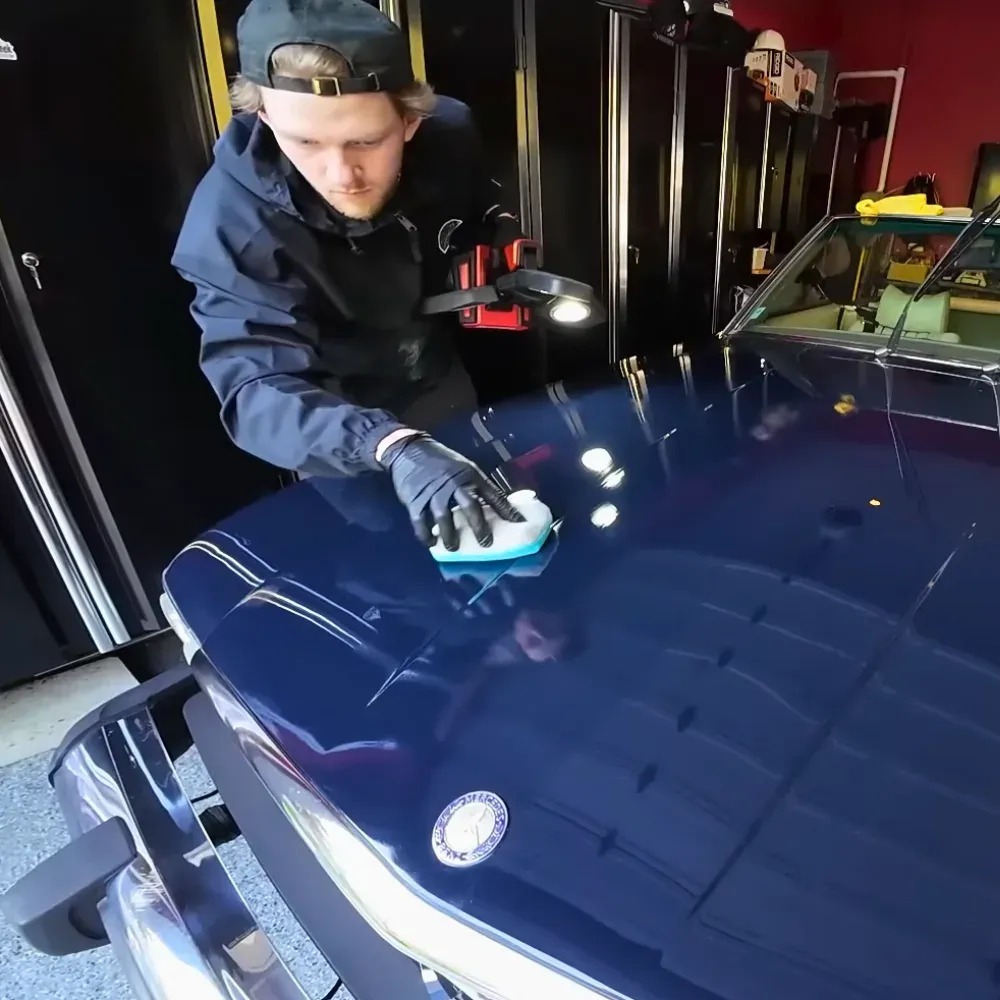 Lucas applying ceramic coating to the hood of a classic Mercedes