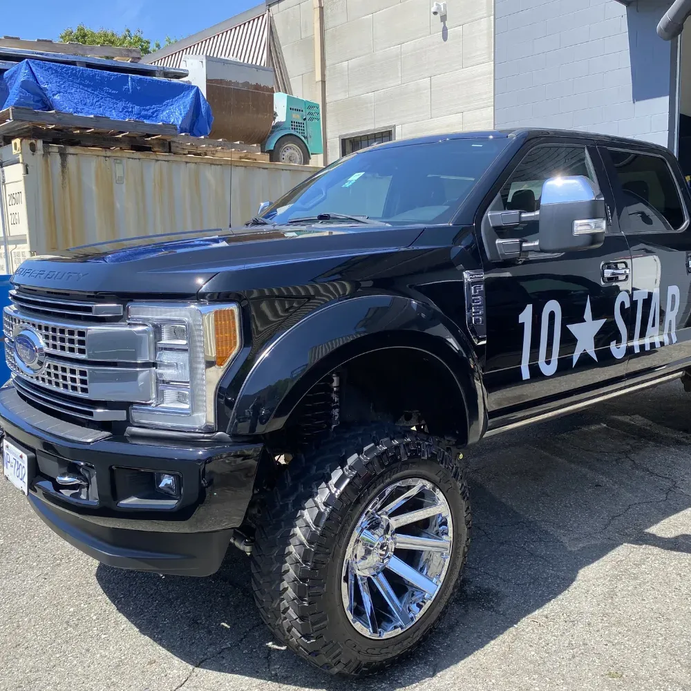 Black lifted Ford Super Duty pickup shining in the sun after an exterior detail